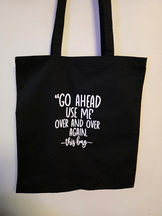 "Go Ahead, Use Me Over and Over Again – This Bag" Black Tote Bag
